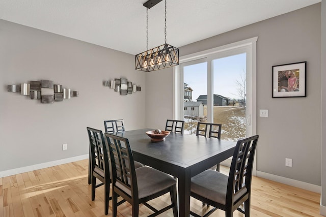 12770 196th Ave NW, Elk River, MN 55330 - dining space with light wood-type flooring, baseboards, and a chandelier