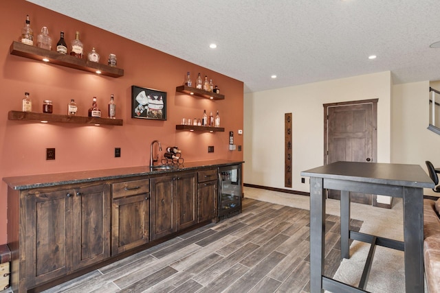 12770 196th Ave NW, Elk River, MN 55330 - indoor wet bar featuring beverage cooler, recessed lighting, wood finished floors, a textured ceiling, and baseboards
