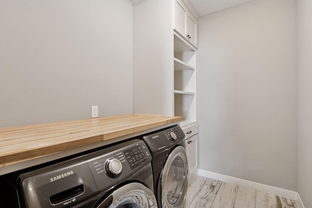 12770 196th Ave NW, Elk River, MN 55330 - laundry area with washing machine and clothes dryer, cabinet space, and baseboards