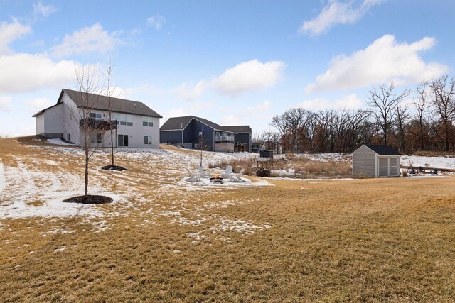 12770 196th Ave NW, Elk River, MN 55330 - yard covered in snow featuring a storage unit, an outbuilding, and a yard