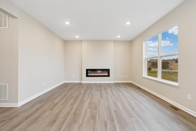 unfurnished living room featuring light hardwood / wood-style flooring