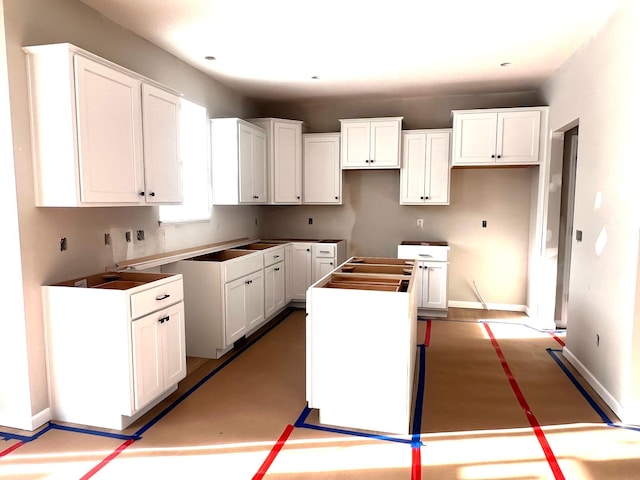 kitchen featuring a kitchen island and white cabinets