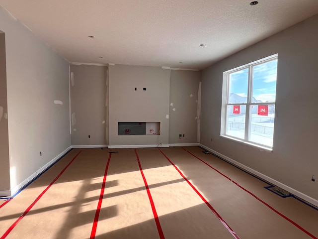 unfurnished living room with a textured ceiling