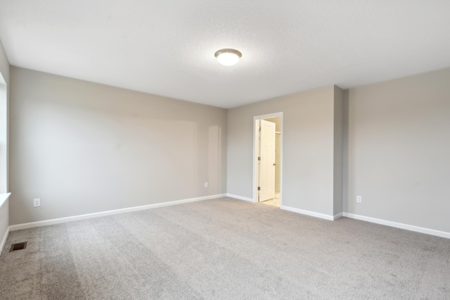 unfurnished room featuring carpet floors