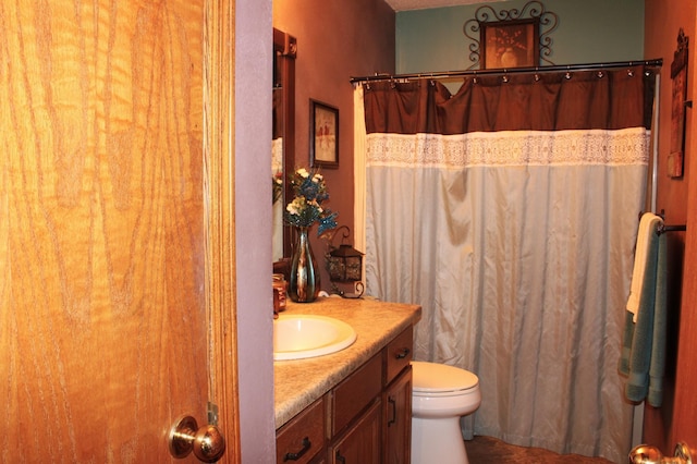 bathroom featuring vanity, toilet, and a shower with curtain