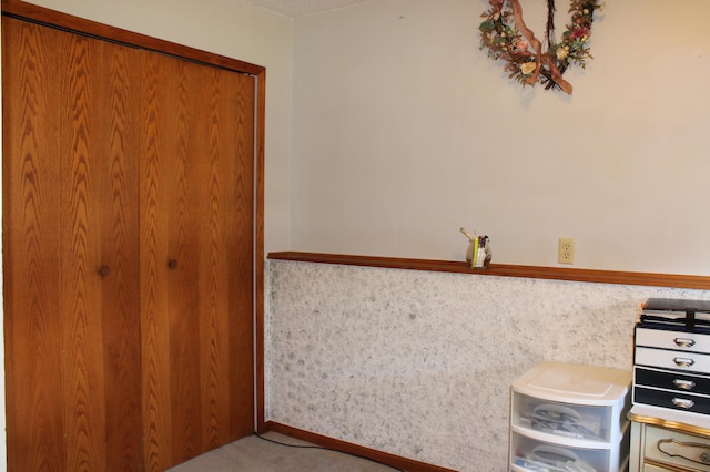 interior space with wainscoting and carpet flooring