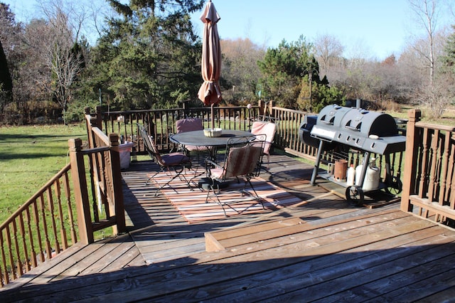 wooden terrace with a yard and outdoor dining space