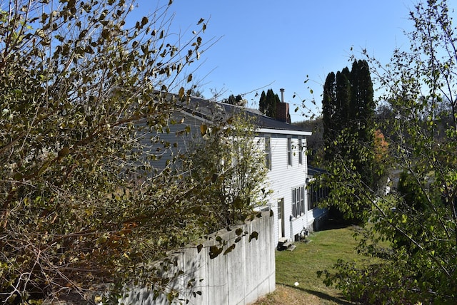 view of property exterior with a lawn