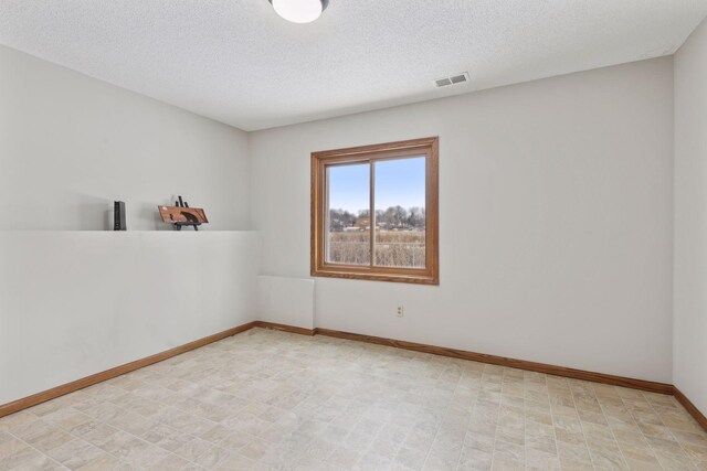 empty room featuring a textured ceiling