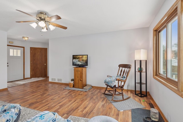 living room featuring hardwood / wood-style flooring and ceiling fan