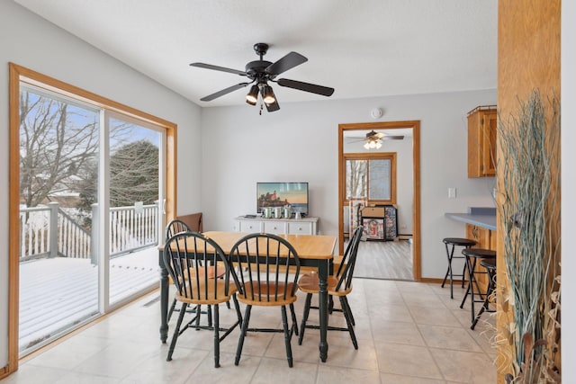 tiled dining space with ceiling fan