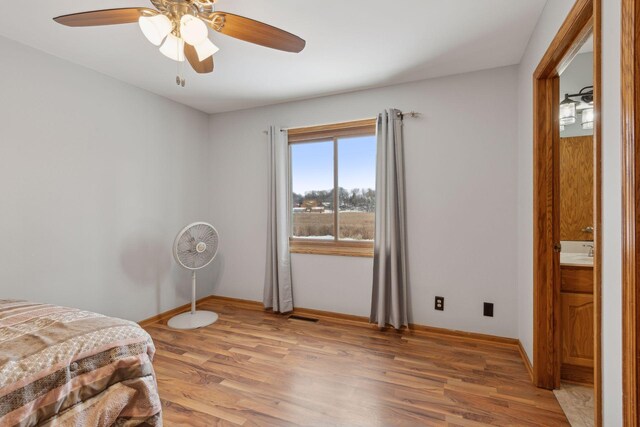 bedroom with ceiling fan and wood-type flooring