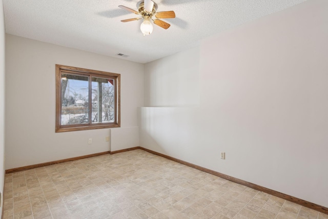 spare room with ceiling fan and a textured ceiling