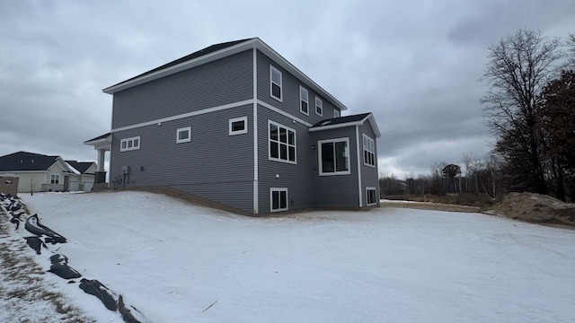 view of snow covered rear of property