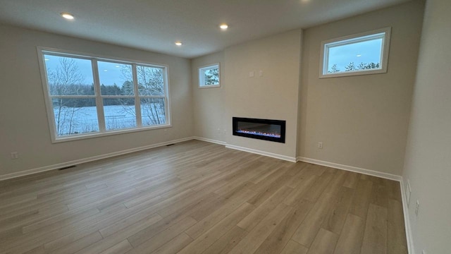 unfurnished living room with light hardwood / wood-style flooring