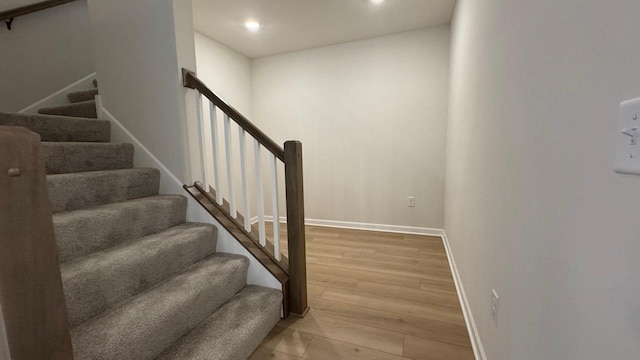 stairway featuring wood-type flooring