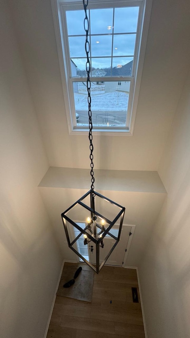 interior details featuring hardwood / wood-style flooring and a chandelier