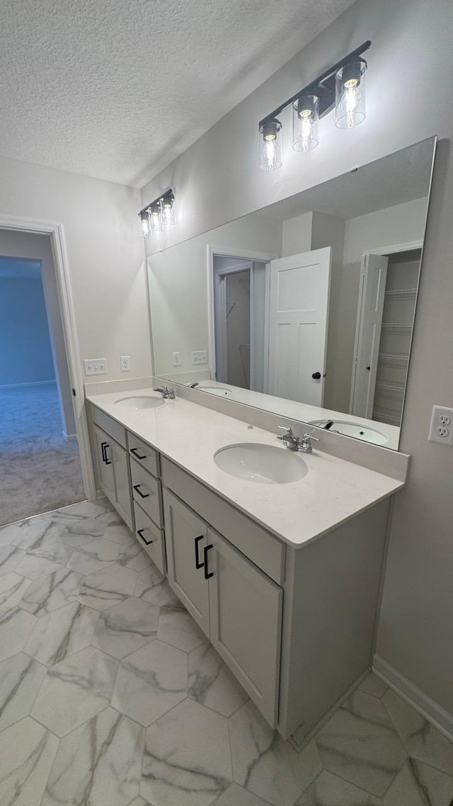 bathroom with a textured ceiling and vanity