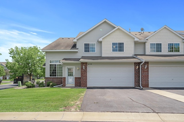 view of front of home featuring a garage and a front lawn