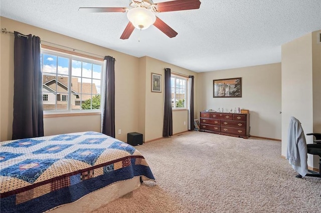 bedroom with carpet, a textured ceiling, and ceiling fan