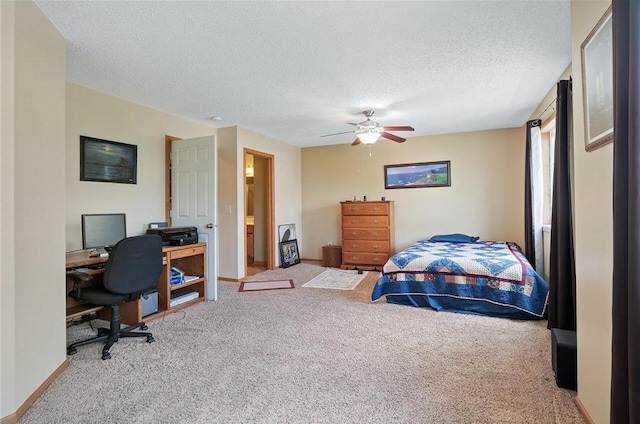 bedroom featuring ensuite bath, ceiling fan, a textured ceiling, and carpet flooring