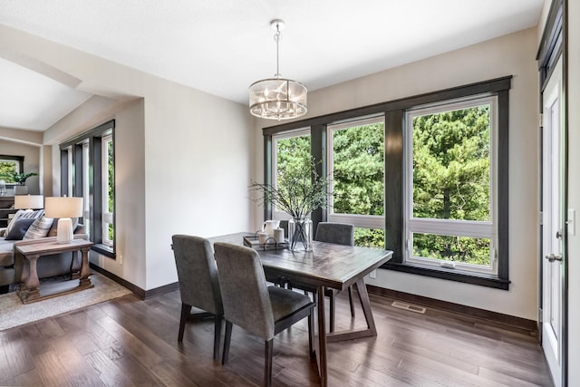 dining room featuring dark hardwood / wood-style flooring and a notable chandelier