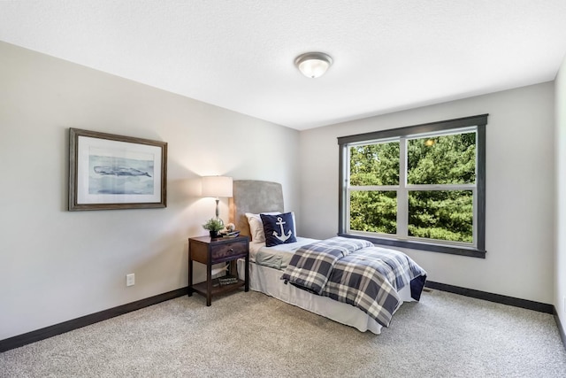 carpeted bedroom featuring a textured ceiling