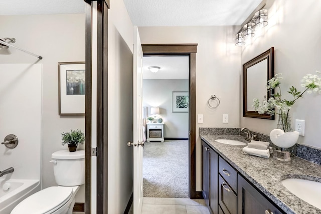 full bathroom featuring washtub / shower combination, a textured ceiling, vanity, and toilet