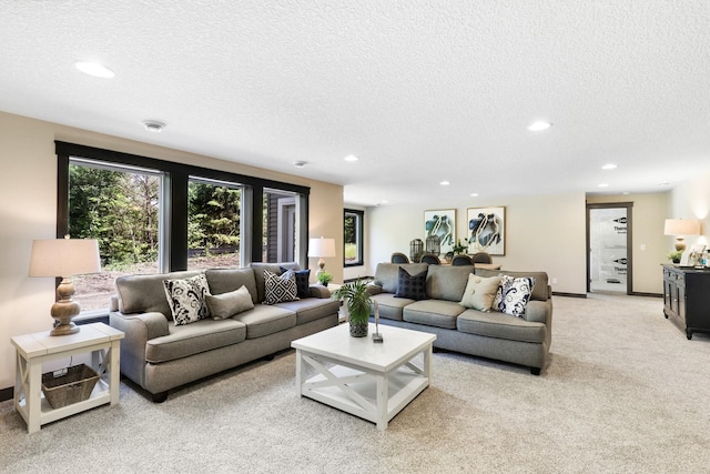 living room with light colored carpet and a textured ceiling