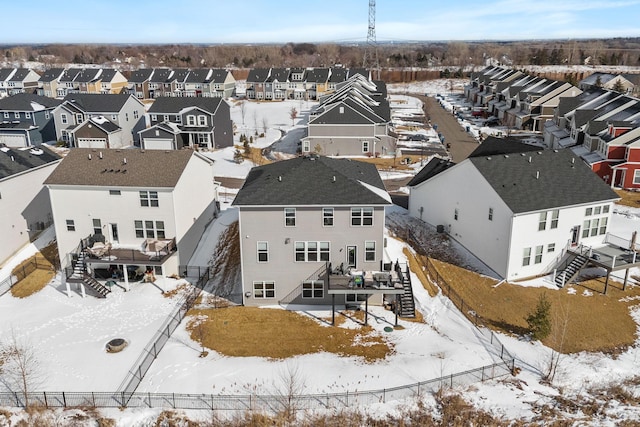 snowy aerial view featuring a residential view