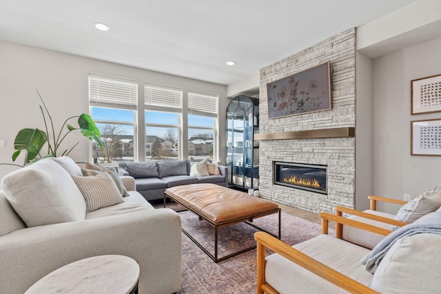 living area with recessed lighting, wood finished floors, and a fireplace