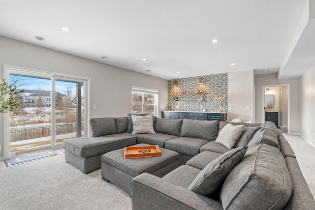 living room with light carpet, recessed lighting, and baseboards