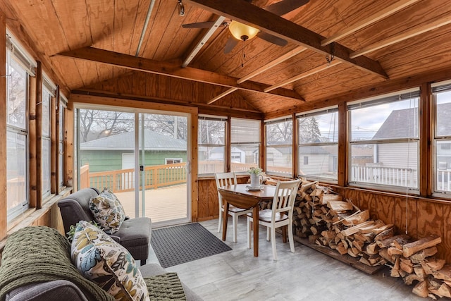 sunroom featuring vaulted ceiling with beams, ceiling fan, and wooden ceiling