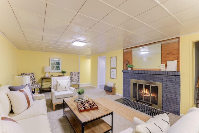 carpeted living room with a brick fireplace