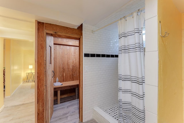 bathroom featuring wood-type flooring and curtained shower