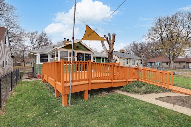 exterior space with a sunroom, a yard, and a wooden deck