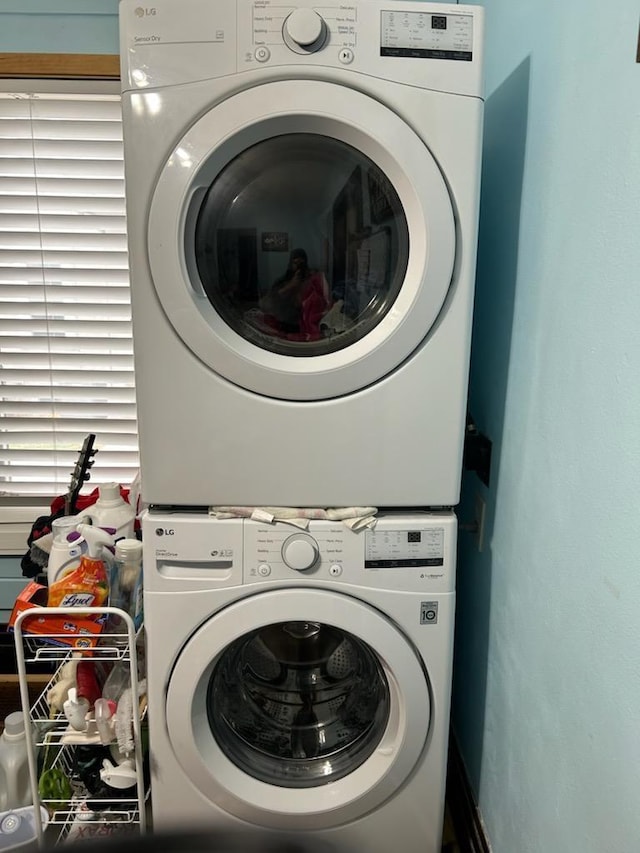 laundry room with stacked washer / dryer