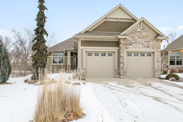 craftsman-style house featuring an attached garage, stone siding, and roof with shingles