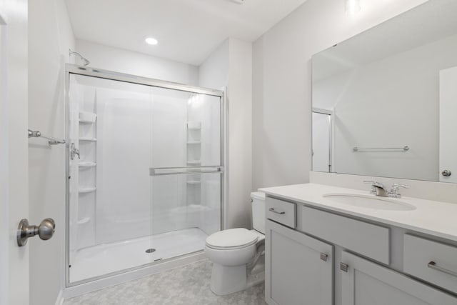 bathroom with vanity, toilet, and an enclosed shower