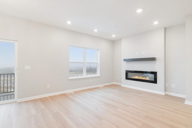 unfurnished living room with light hardwood / wood-style flooring