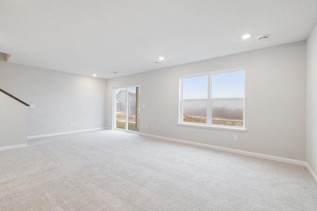 unfurnished room with light colored carpet