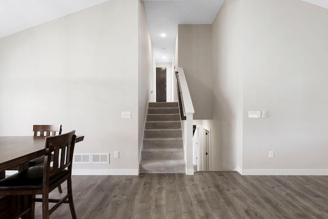 staircase with recessed lighting, wood finished floors, visible vents, and baseboards