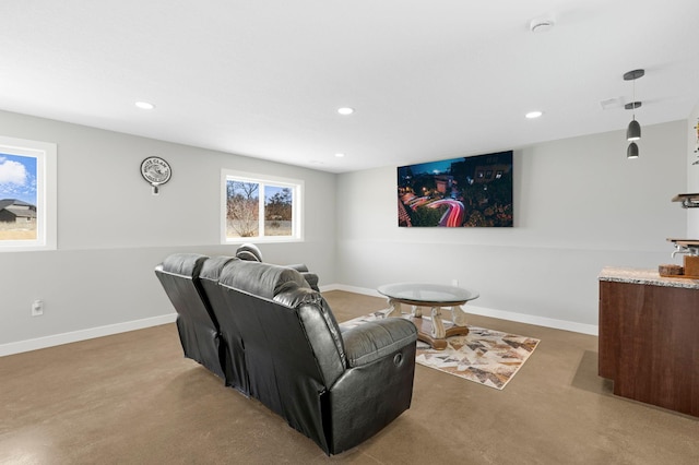 living area with baseboards and recessed lighting