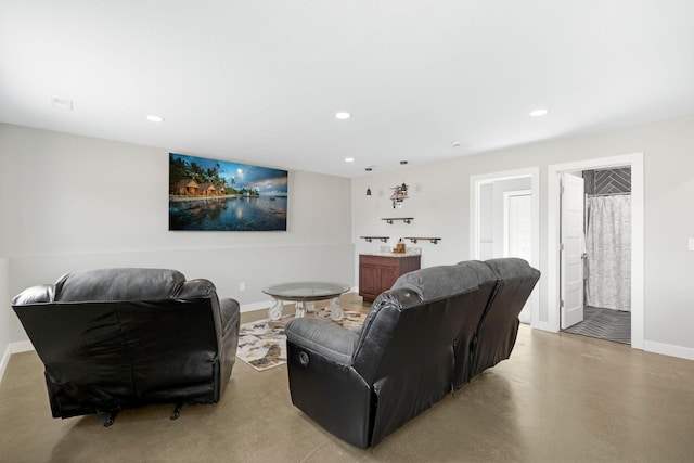 living room with finished concrete flooring, baseboards, and recessed lighting