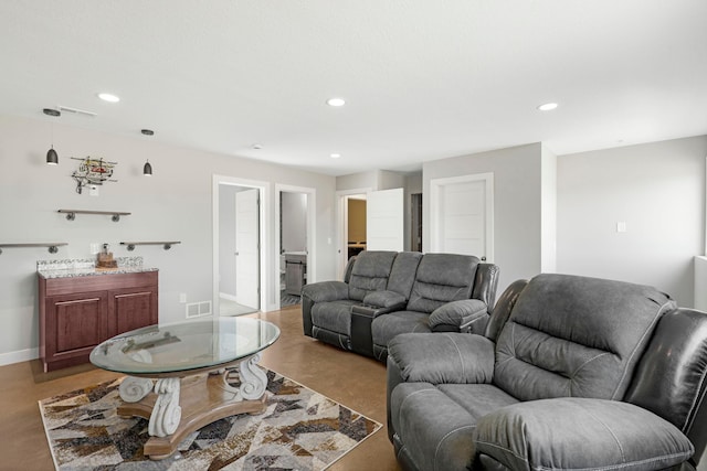 living area with baseboards, visible vents, and recessed lighting