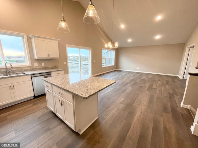 kitchen with a center island, dishwasher, white cabinets, sink, and high vaulted ceiling