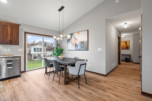 dining room featuring visible vents, baseboards, vaulted ceiling, and light wood finished floors