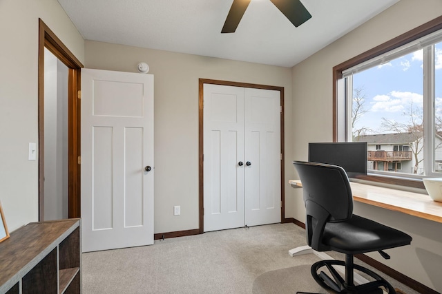 office with light carpet, baseboards, and ceiling fan