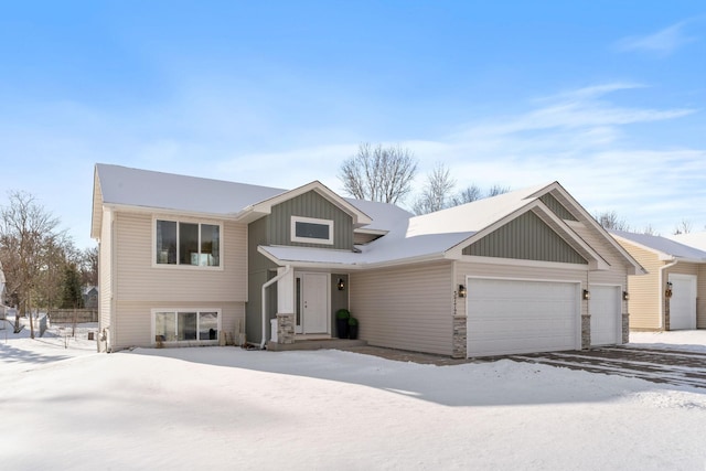 view of front facade featuring stone siding, board and batten siding, and an attached garage