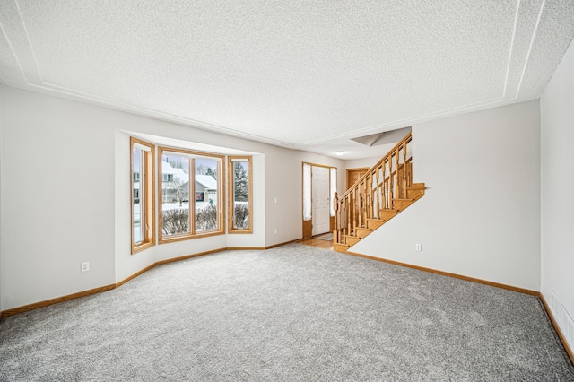 empty room featuring carpet floors and a textured ceiling